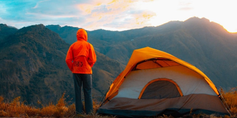 Cyclists camping in Wilpattu National Park with tents and bicycles against a scenic wilderness backdrop